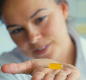 Woman holding a piece of gummy candy